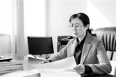 圖為王希鳳在查閱案件資料。蘇麟 供圖